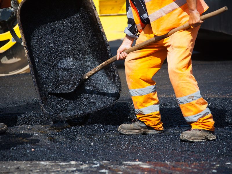 guy spreading asphalt